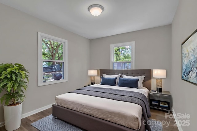 bedroom featuring wood finished floors and baseboards