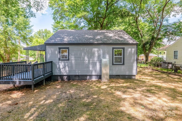 view of outdoor structure featuring fence and central AC unit