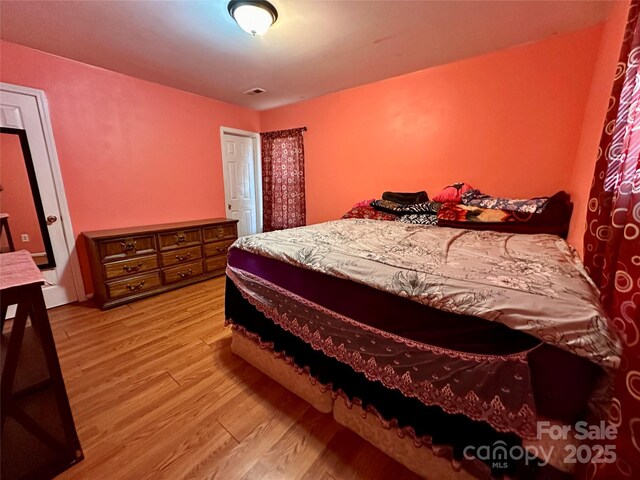 bedroom featuring visible vents and light wood-type flooring