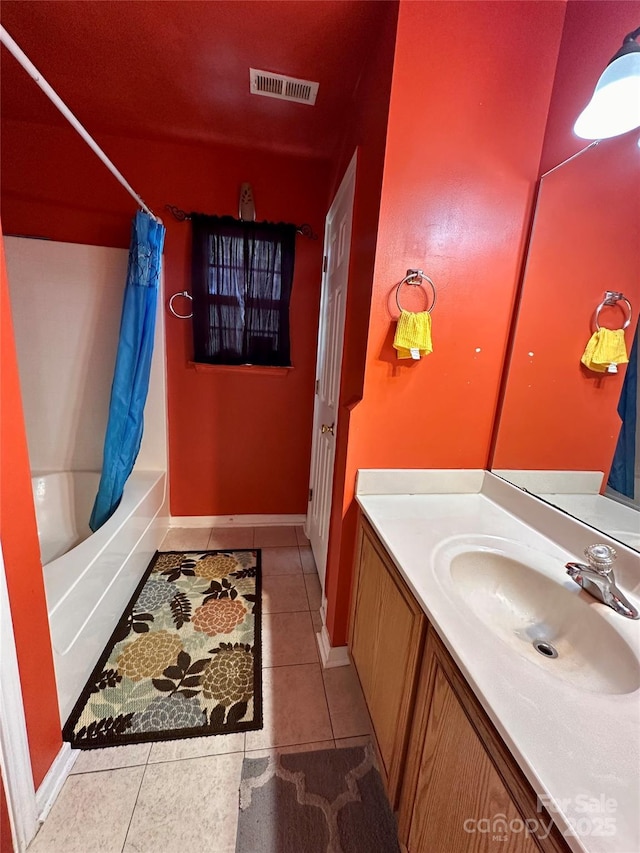 bathroom featuring vanity, visible vents, shower / tub combo with curtain, tile patterned floors, and baseboards