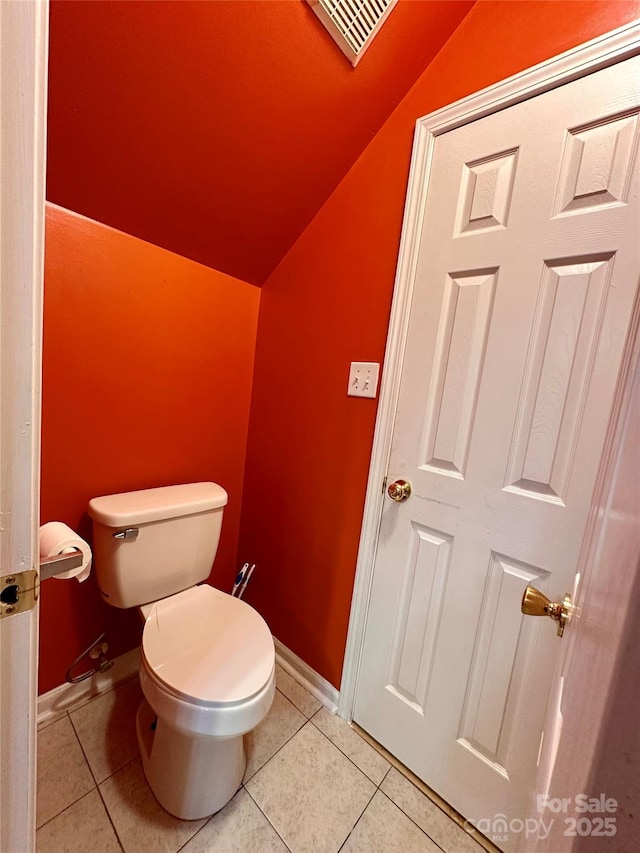 bathroom with tile patterned flooring, visible vents, toilet, and lofted ceiling