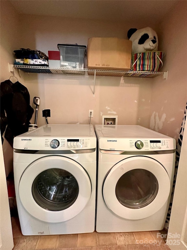 laundry area featuring separate washer and dryer and laundry area