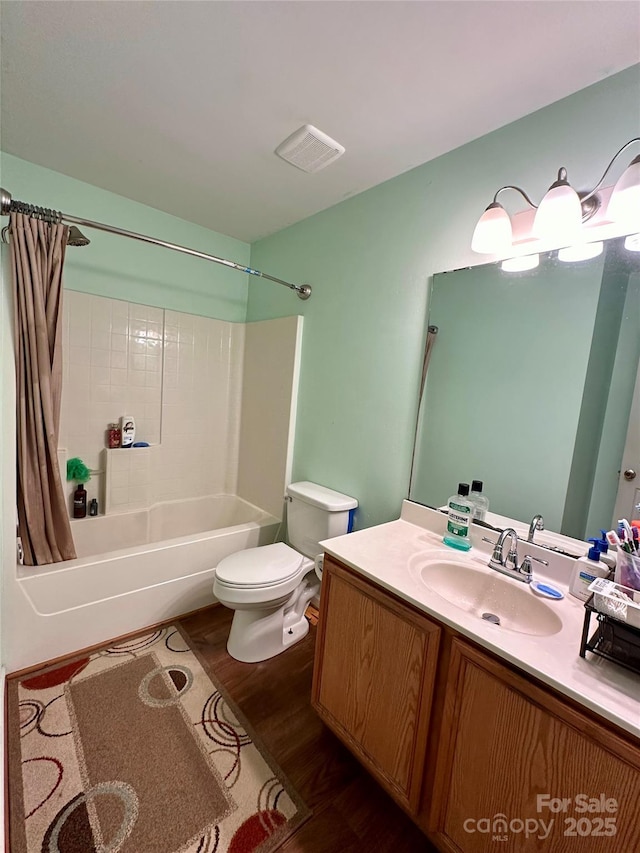 full bath featuring vanity, visible vents, toilet, wood finished floors, and shower / tub combo