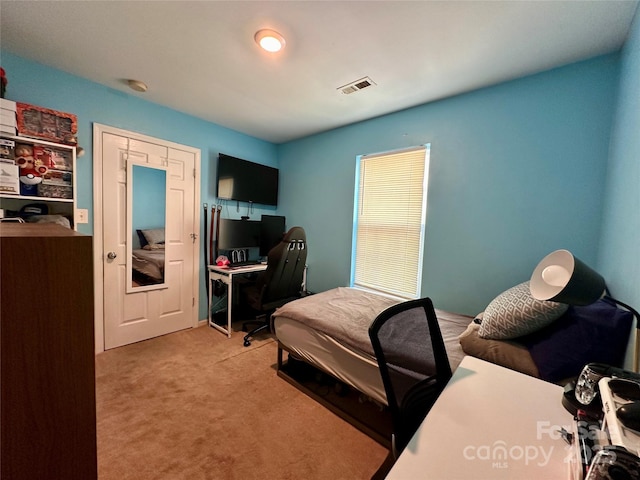 bedroom with visible vents and light colored carpet