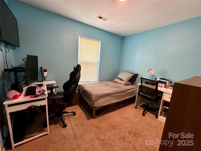 bedroom with visible vents and carpet