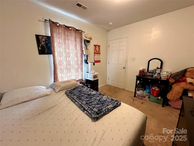 bedroom with visible vents and carpet flooring