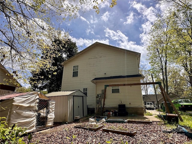 rear view of property with a shed and an outbuilding