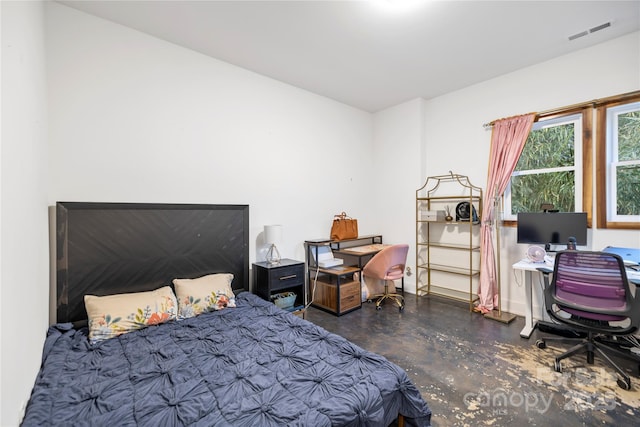 bedroom with visible vents and finished concrete floors