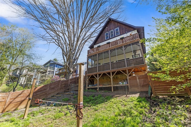 back of house with a fenced backyard