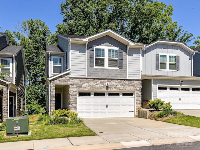 view of front of property with stone siding, an attached garage, and concrete driveway