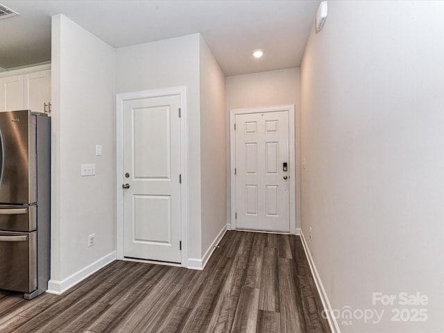 entryway with dark wood finished floors, baseboards, and recessed lighting