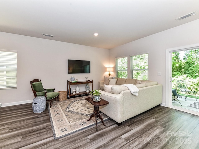 living area featuring dark wood finished floors, baseboards, and recessed lighting