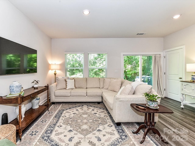 living area featuring wood finished floors and recessed lighting