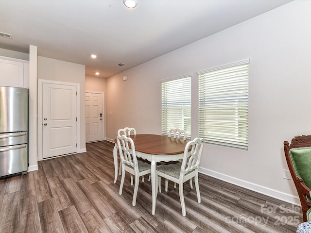 dining area with dark wood-type flooring, baseboards, and recessed lighting