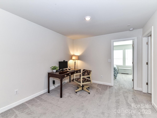 carpeted home office with baseboards