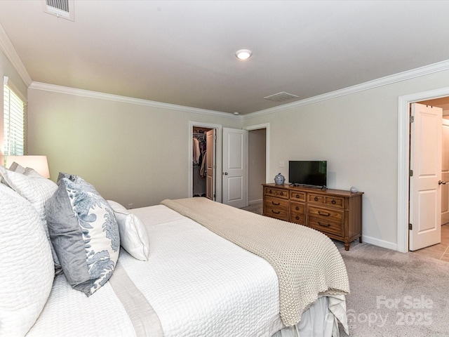 bedroom featuring ornamental molding, a spacious closet, light colored carpet, baseboards, and a closet