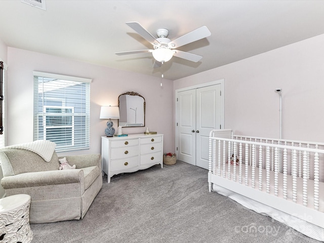 carpeted bedroom featuring a closet and ceiling fan