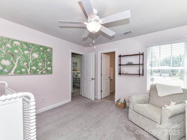 living area with ceiling fan, baseboards, and carpet