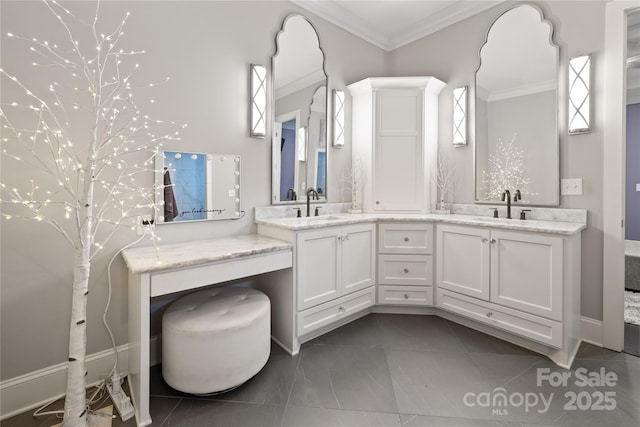 bathroom featuring crown molding, a healthy amount of sunlight, double vanity, and a sink