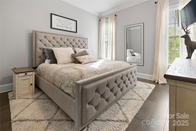 bedroom with crown molding, wood finished floors, baseboards, and multiple windows