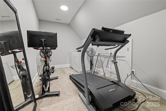 workout room featuring wood finished floors, visible vents, baseboards, and washing machine and dryer