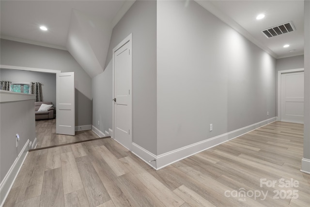 additional living space with light wood finished floors, baseboards, visible vents, and recessed lighting