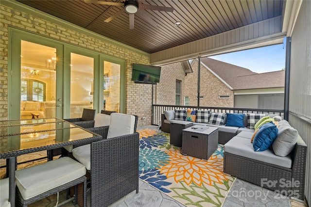 view of patio / terrace featuring french doors, an outdoor living space, ceiling fan, and outdoor dining space