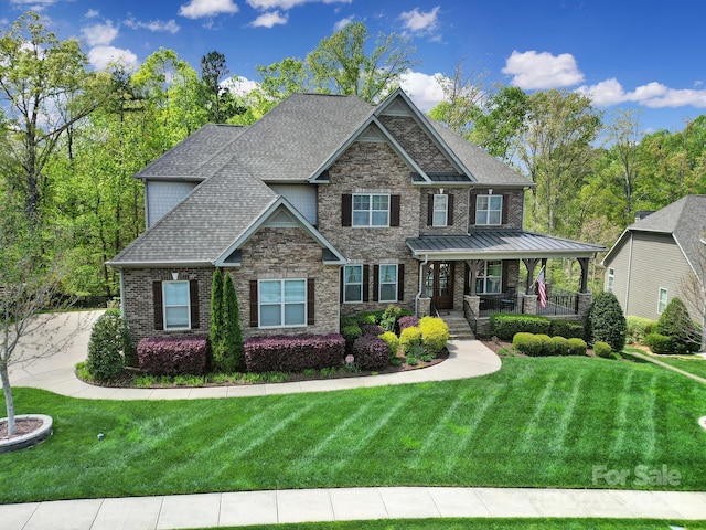 141 Forsythia Ln, Tega Cay, SC 29708 - craftsman-style home featuring a porch, a front yard, stone siding, brick siding, and a shingled roof