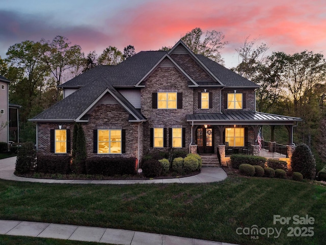 141 Forsythia Ln, Tega Cay, SC 29708 - view of front of house featuring roof with shingles, a porch, stone siding, and a front lawn