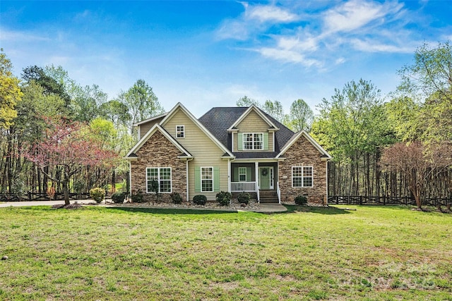 craftsman house with stone siding and a front lawn