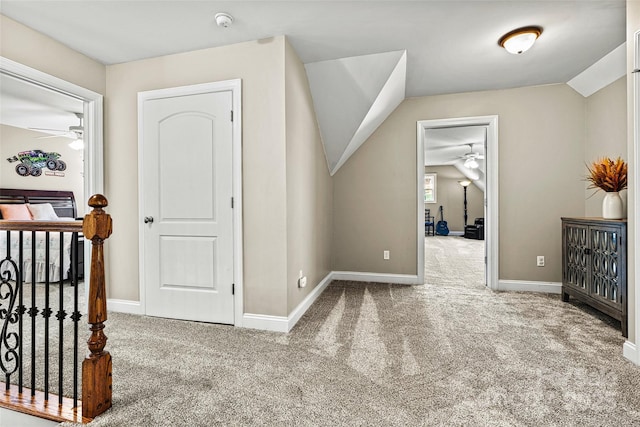 additional living space with carpet, ceiling fan, and vaulted ceiling