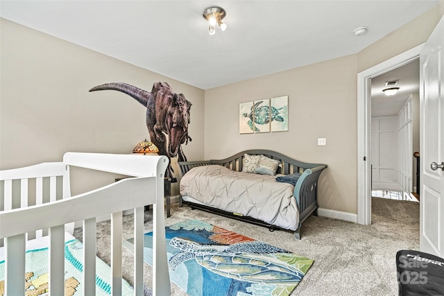 bedroom featuring baseboards and carpet flooring