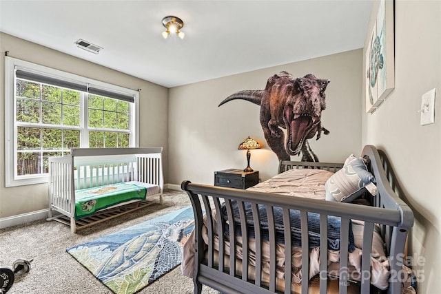 carpeted bedroom featuring visible vents and baseboards