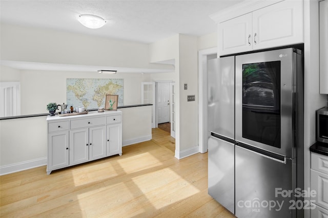 4075 Little River Rd, Hendersonville, NC 28739 - kitchen featuring stainless steel appliances, light wood-style flooring, and white cabinets