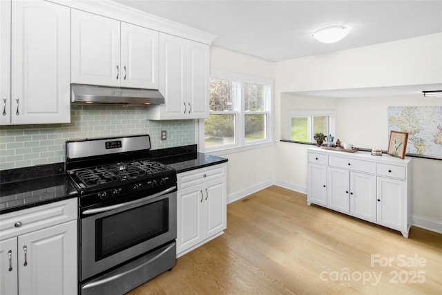 4075 Little River Rd, Hendersonville, NC 28739 - kitchen with stainless steel range with gas cooktop, under cabinet range hood, light wood-style flooring, backsplash, and white cabinets