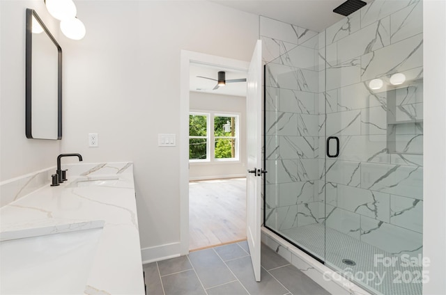 2512 Remington St, Charlotte, NC 28216 - bathroom with a marble finish shower, double vanity, tile patterned floors, baseboards, and a ceiling fan