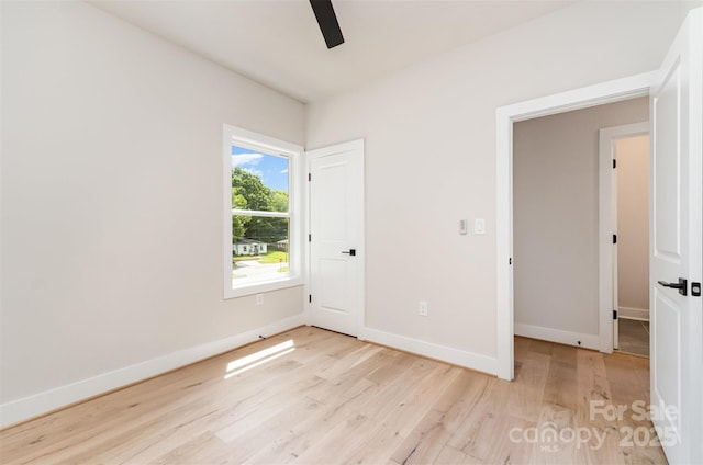 2512 Remington St, Charlotte, NC 28216 - unfurnished bedroom with light wood-style floors, baseboards, and a ceiling fan