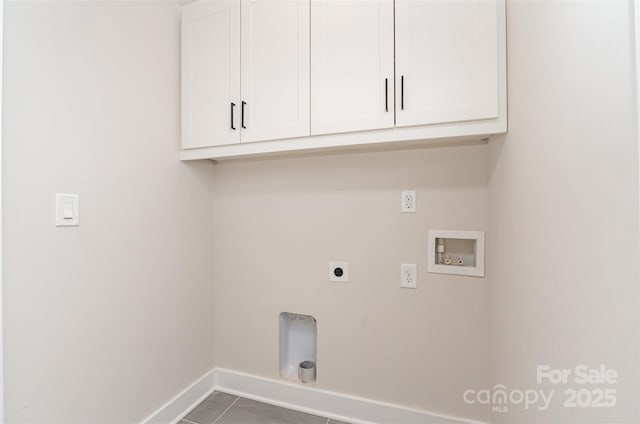 2512 Remington St, Charlotte, NC 28216 - laundry area featuring baseboards, hookup for a washing machine, cabinet space, electric dryer hookup, and tile patterned flooring