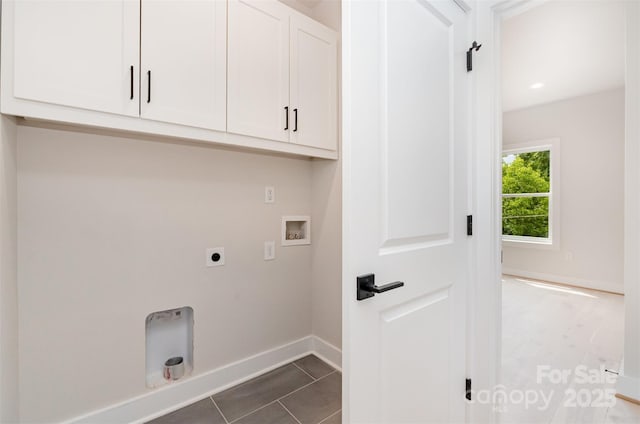 2512 Remington St, Charlotte, NC 28216 - washroom featuring cabinet space, hookup for an electric dryer, hookup for a washing machine, baseboards, and dark tile patterned flooring
