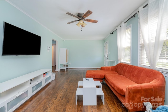 living room with baseboards, wood finished floors, crown molding, and ceiling fan