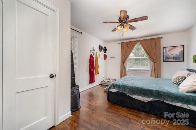 bedroom with baseboards, a ceiling fan, and wood finished floors