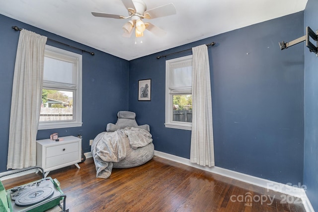 bedroom featuring ceiling fan, baseboards, and wood finished floors