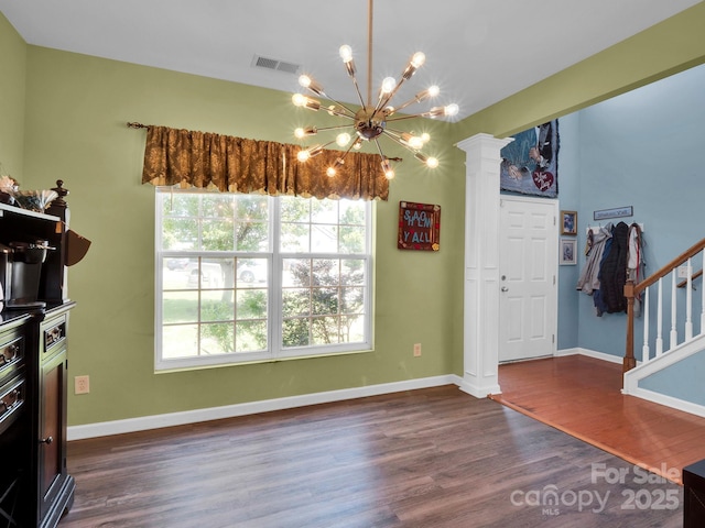 5102 Candleglow Ct, Indian Trail, NC 28079 - dining room with dark wood-style flooring, an inviting chandelier, baseboards, decorative columns, and visible vents