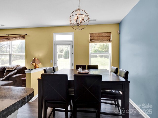 5102 Candleglow Ct, Indian Trail, NC 28079 - dining space featuring baseboards, a notable chandelier, a wealth of natural light, and wood finished floors