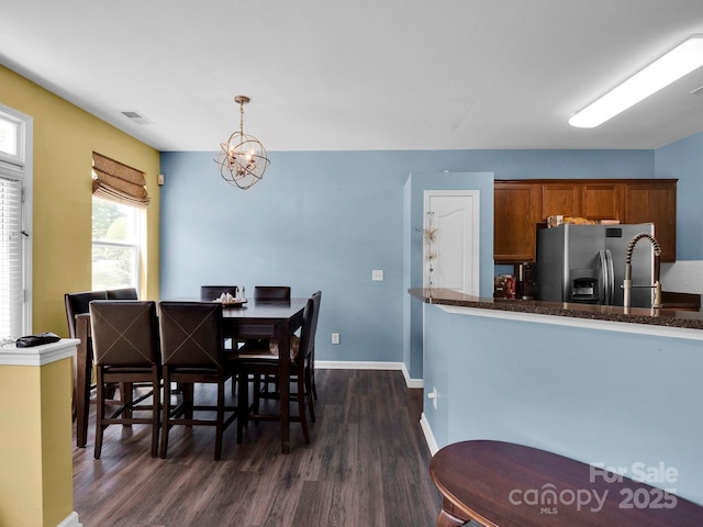 5102 Candleglow Ct, Indian Trail, NC 28079 - dining room featuring an inviting chandelier, baseboards, dark wood-style floors, and visible vents