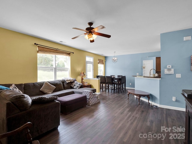 5102 Candleglow Ct, Indian Trail, NC 28079 - living room featuring dark wood-type flooring, baseboards, ceiling fan with notable chandelier, and visible vents