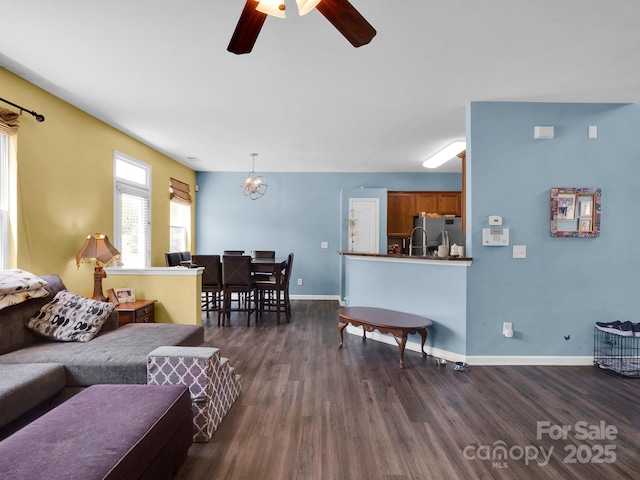 5102 Candleglow Ct, Indian Trail, NC 28079 - living area featuring baseboards, dark wood-style flooring, and ceiling fan with notable chandelier