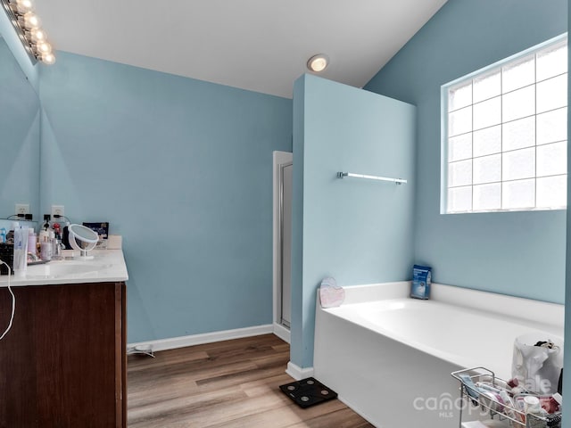 5102 Candleglow Ct, Indian Trail, NC 28079 - full bath featuring vanity, baseboards, a bath, and wood finished floors