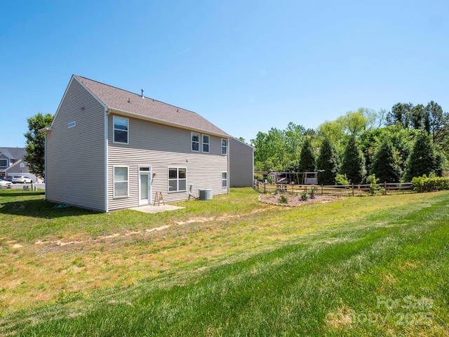 5102 Candleglow Ct, Indian Trail, NC 28079 - rear view of house with fence, a lawn, and cooling unit