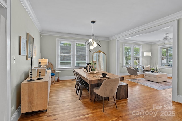 dining room featuring ceiling fan, light wood-type flooring, baseboards, and ornamental molding